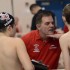 Head Swim Coach Greg Fisher speaks with some of his swimmers about technique prior to a race.
