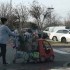 A woman exiting Kroger is carrying her items in plastic bags. If this were in Dallas, she would have to pay a fee to use such bags.