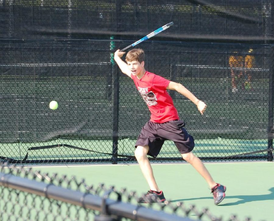 Freshman Cole Bennett plays a tennis match with his doubles partner, freshman Grady Wells.