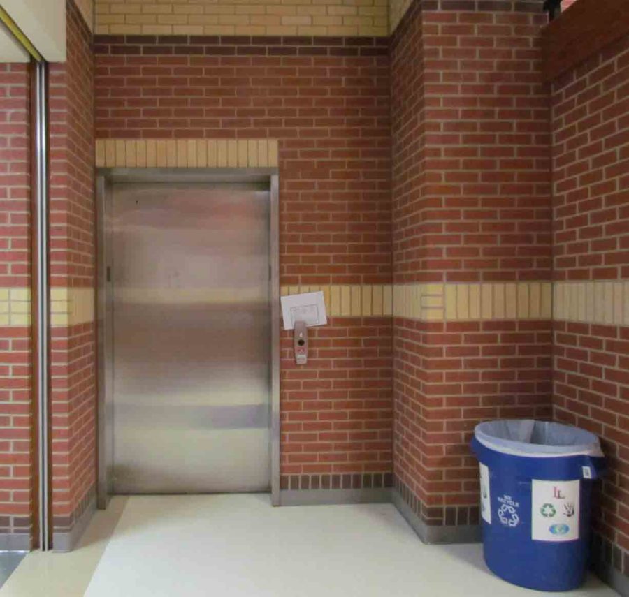 Off to the side and across from the teacher's lounge, the school's lone elevator is the focus of a growing debate as to who can use it and when.