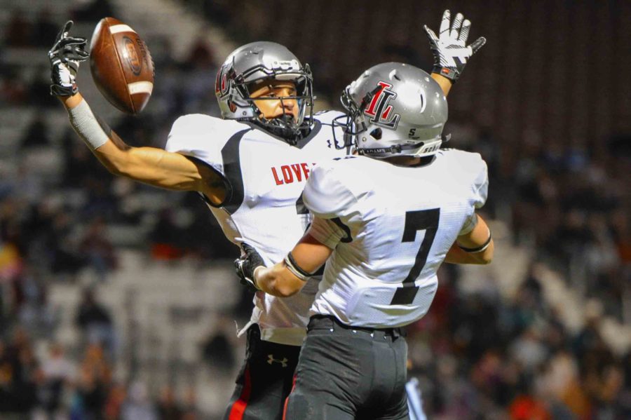 After+the+first+touchdown+of+the+game%2C+sophomore+Aaron+Fuller+celebrates+the+strong+start+with+senior+Grant+Jarvis.+This+strong+start+led+to+a+win+and+the+clenching+of+playoffs.+