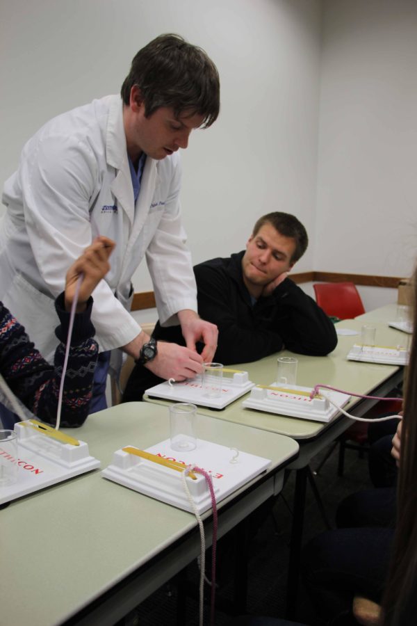 Students studying health science received help and instruction from medical professionals, like senior Jacob Poteet. 