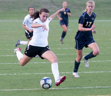 Junior Dominique Mazero dribbles in last years playoof match aganist Highland Park, this year, they are working to win district. 