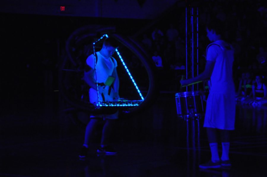 Senior Mason Olk and Junior Cole Stretcher perform their percussion routine during the Black Light Pep Rally Friday, April 11, 2014.
