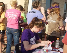 Students and staff work at the front booth of Relay for Life in 2014. The third annual Relay for Life is Friday, March 27 from 7 p.m. to 7 a.m.