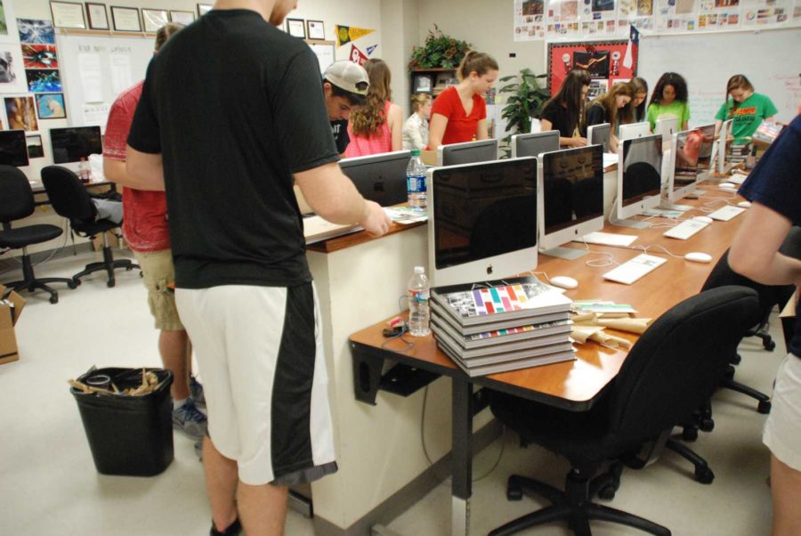 The Yearbook staff look through the Yearbooks.