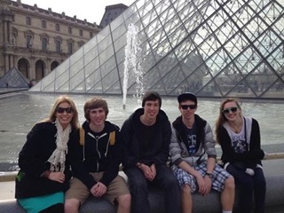 French teacher, Summer Moseley, took a group of students to France over Spring Break, and will take another group over summer. About, students pose in front of Louvre in Paris, France.   