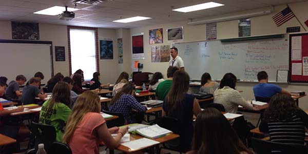 Teacher Kevin Finn instructs his students on the history of the world, even with a new AP drop policy.