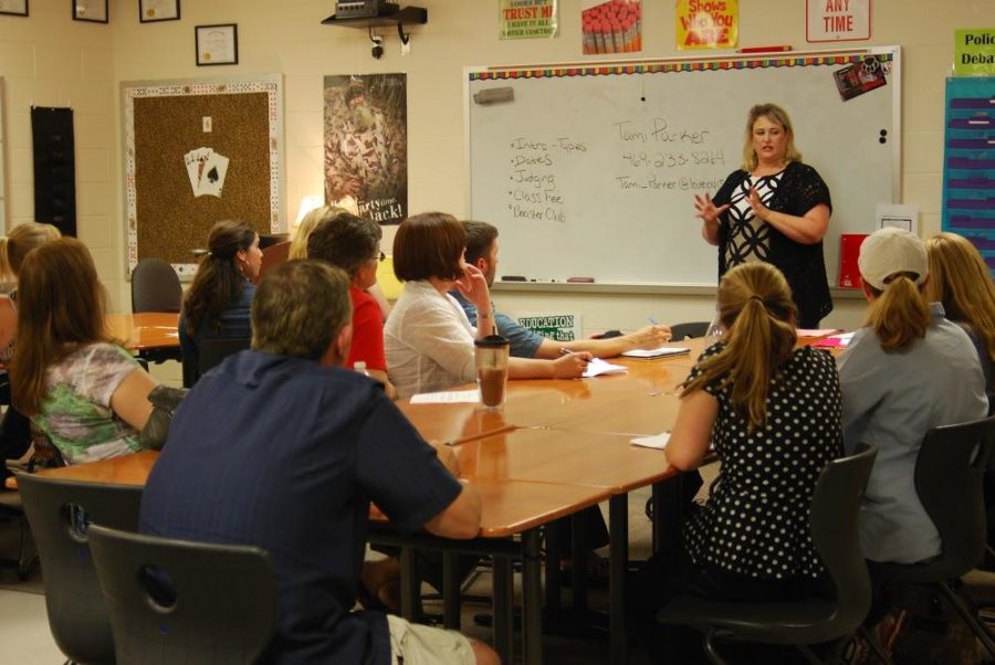 Debate teacher Tami Parker, informs parents about the workload for the year. 