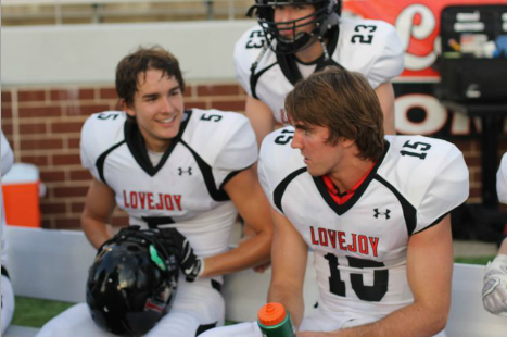 Senior Adam McDaniel and junior Bowman Sells sit on the sidelines during the Mansfield Legacy game.