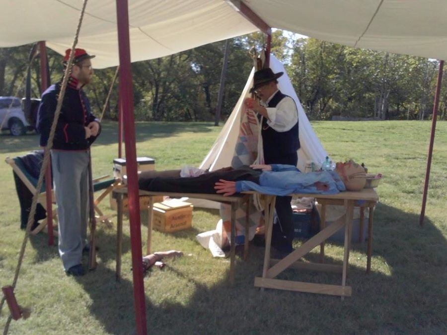 Two participants in Allens Civil War reenactment teart a patient.