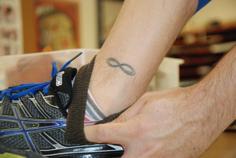 Art teacher Jeff Seidel, and former tattoo flash artist, shows off his infinity tattoo.