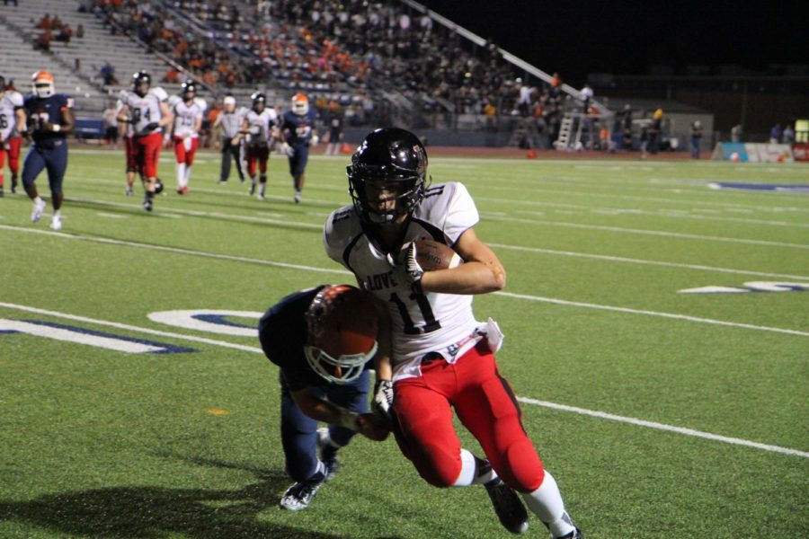 Sophomore Wide Receiver Steven Prudhomme (11) tries to avoid getting pushed out of bounds as he approaches the five-yard line. 