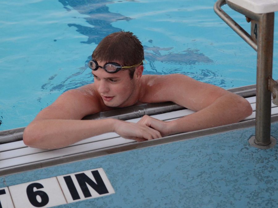 Senior Drew Carson rests between races in the pool. On Tuesday, October 28, 2014, against McKinney North at 5:30 at McKinney High School.