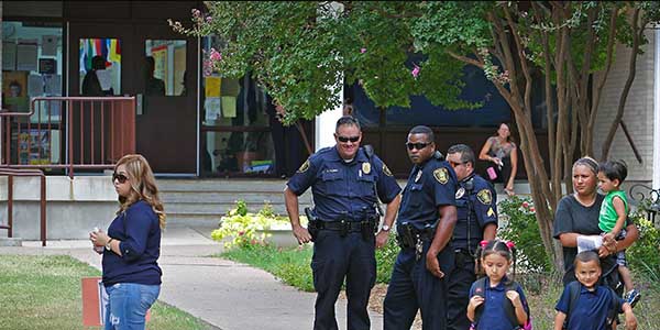 As DISD Police watch, Gabriella Beltran, right, walks from Hotchkiss Elementary with her children Valeria Curranza, Joseph Manuel Beltran and Oliver Torres. Parents were summoned by the Dallas School District to pick their children up early from L.L. Hotchkiss Elementary, Wednesday, October 1, 2014. Children who had reportedly been near the man who has been diagnosed with the Ebola virus have attended the school. 