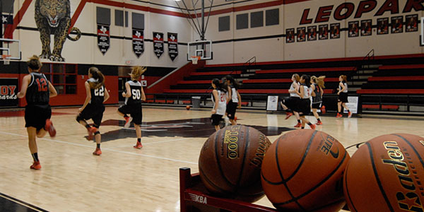 Girls basketball players warm up for one of their first practices of the season after school on Tuesday, October 28, 2014.