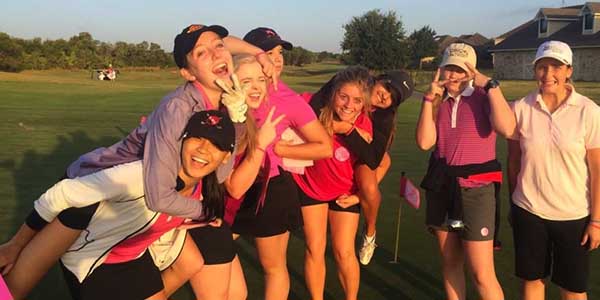 The girls golf team goofs off on Tuesday, Oct. 7 before the start of the Pink Out Tournament in support of Breast Cancer at Westridge Golf Course in McKinney. The tournament is the team's first on its fall tournament schedule.