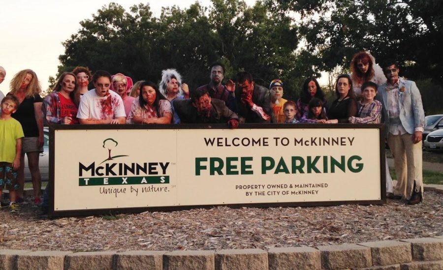 Cooper and other participants pose with the town of McKinney sign before continuing their shuffle into the downtown square of McKinney.
