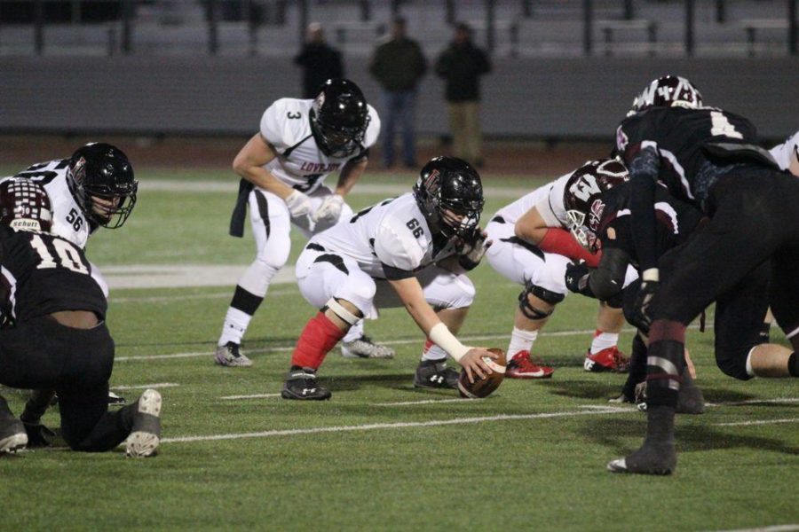 Sophomore offensive lineman Cole Egger (66) prepares to snap the ball back to Bowman Sells.