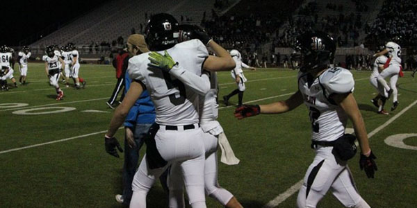 After an exciting leopard victory, Adam McDaniel (5) celebrates with a teammate. 