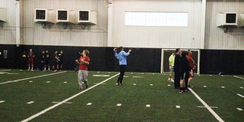 During a walkthrough before the first Leopard playoff game, Bowman Sells throws to long-time teammate and receiver Aaron Fuller in the indoor facility. 