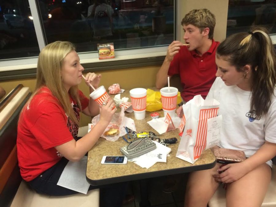 After an away football game, seniors Sam Tillinghast, Claire Becker and Sarah Bower stop for a bite to eat at Whataburger like many local students.