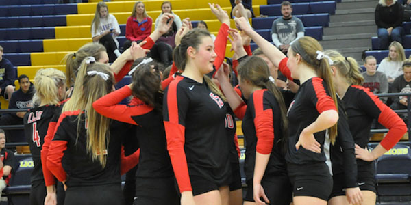 Sarah Langs looks towards the rivaling team as the Leopards raise their hands before the game starts.