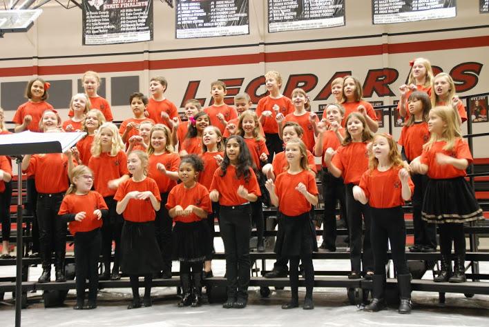 Third and fourth grade students sing songs they’ve prepared for the Fine Arts Festival