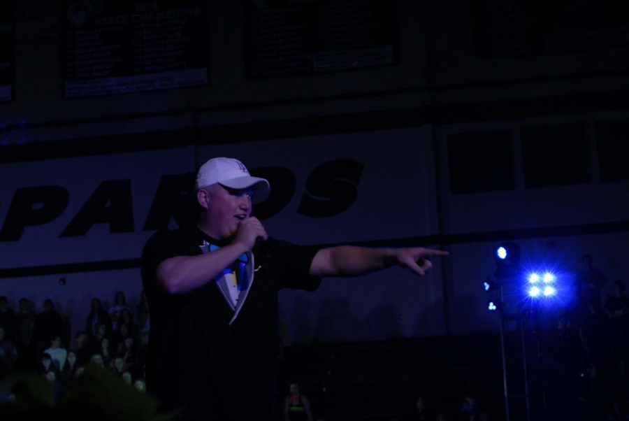 Head football coach, Ryan Cox, led the pep rally in a t shirt with a glowing bow on it. 