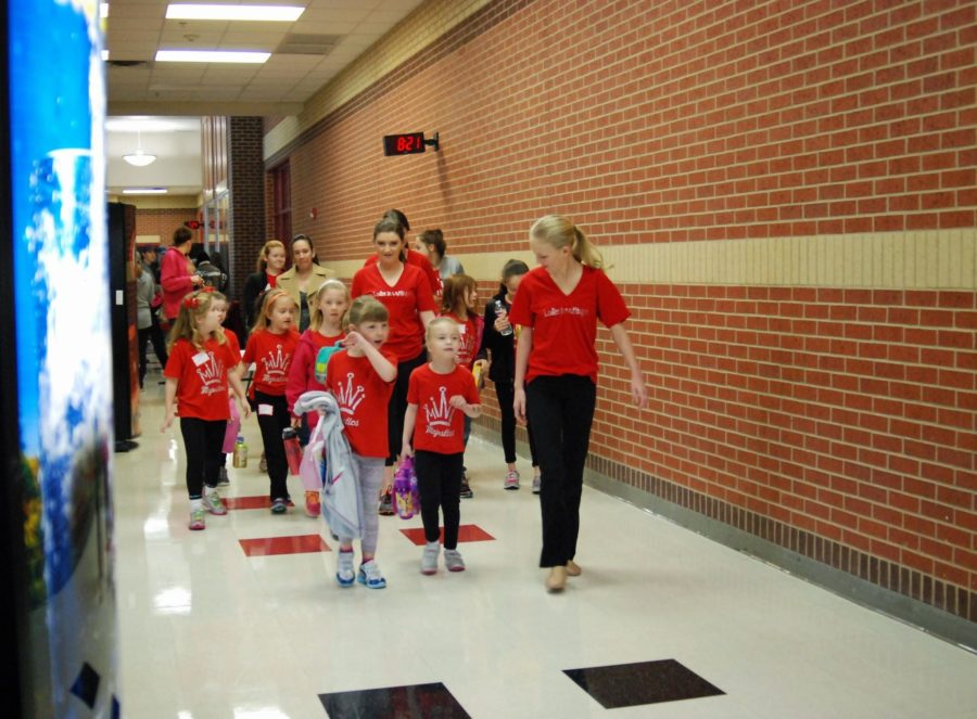 The Ladies in Waiting escort the Mini Majestics to the gym where they join their groups in preparation for the day.