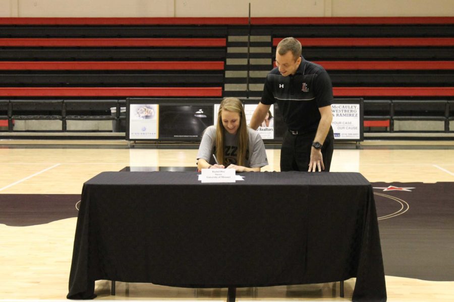 Rachel Hise, along with head girls basketball coach Lance Boxell, signs to play soccer at the University of Missouri.