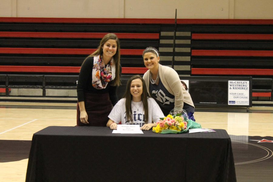 Assistant soccer coach Courtney Todd and head soccer coach Misty Benson pose for a picture after midfielder Dom Mazero signs to play for Rice University.   