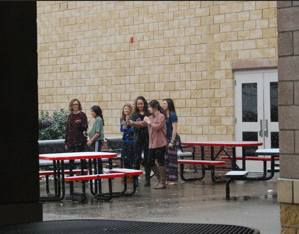 Students take pictures and selfies in the snow during first period. 