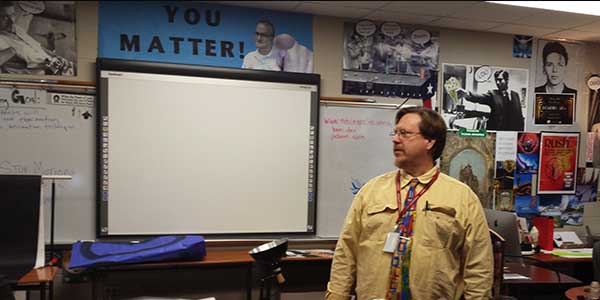 Pre-calculus teacher Andrew Stallings, as an effort by the district to save money, substitutes a class period for digital-media teacher Ray Cooper. 