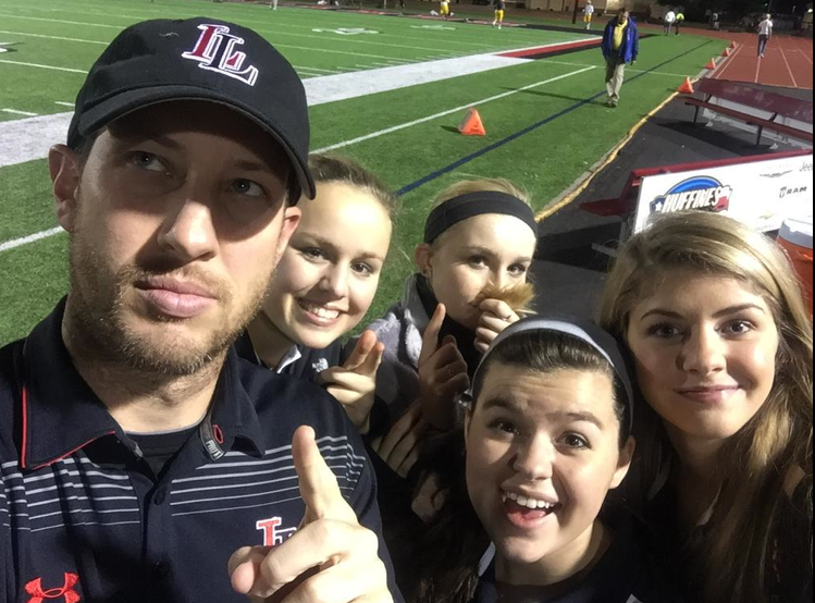 Assistant football coach Phillip Murray is leaving the teach at a Dallas school. Above, he takes a picture for good luck with athletic trainers during football season. 