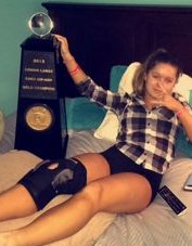 Hannah Weeks poses with her first place world championship trophy. She is wearing a brace after hurting her knee during the performance.