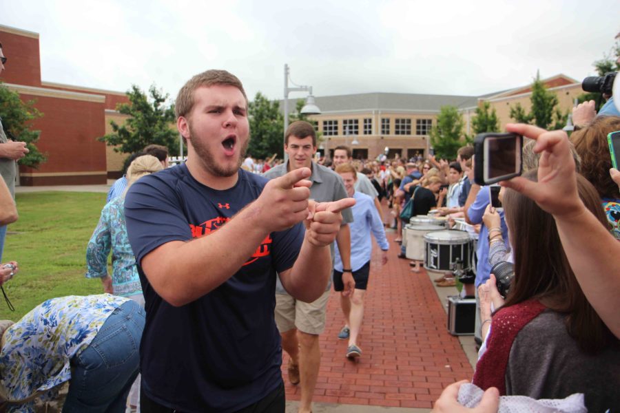 Dan Cole joking with friends and family at the senior walk.