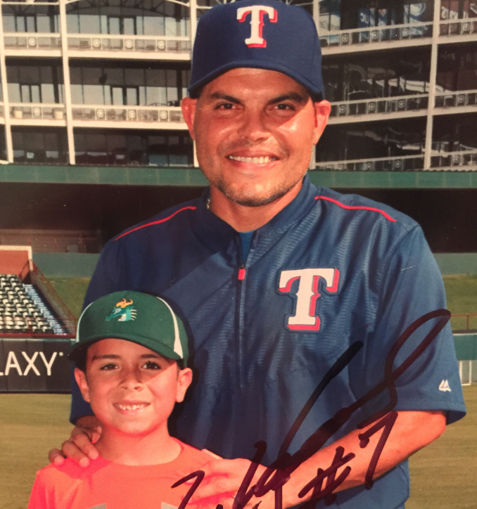 Posing with Texas Rangers baseball legend Ivan Pudge Rodriguez, Lovejoy Elementary second grade student Nicolas Ortega spent some time with Rodriguez at Globe Life Park.