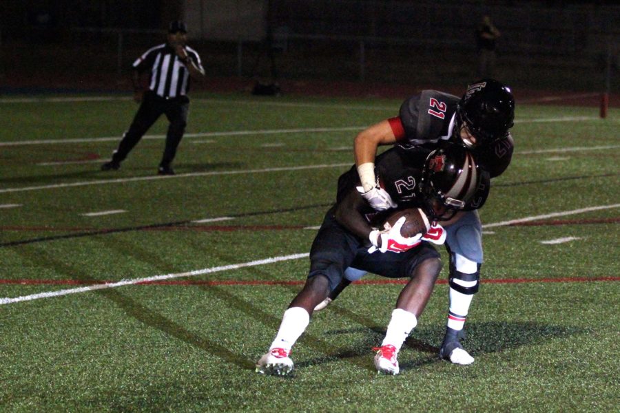 Senior Dakota Michaels (21)  brings down a Mansfield Legacy player during last weeks game.