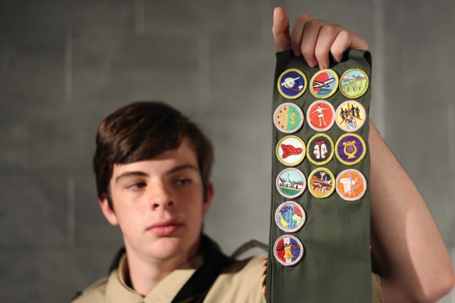 Landon+Bruner+holds+up+his+Eagle+Scout+patches+which+reflect+the+hard+work+he+does+for+the+community.+