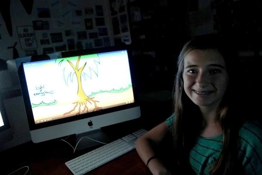 Sophomore Carly Johnson poses next to one of her animations in Ray Coopers class. Animation first caught Johnsons eye in elementary school when she saw a behind-the-scenes commercial on how Tinkerbell was created.
