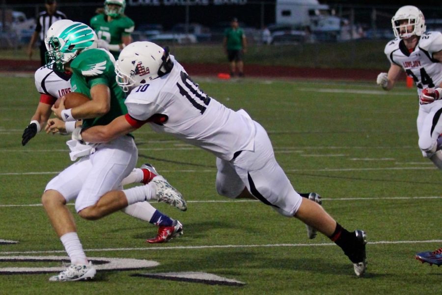 During a game against Lake Dallas High School, Bumper Pool took down the quarterback for a Falcon loss of yards.