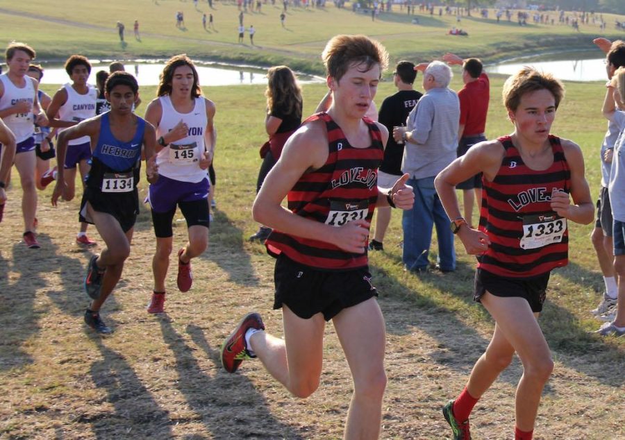 Ryan Brands (Sophomore) and Cole Hinton (Freshman) run side by side at Lovejoy Cross Country Fall Festival.