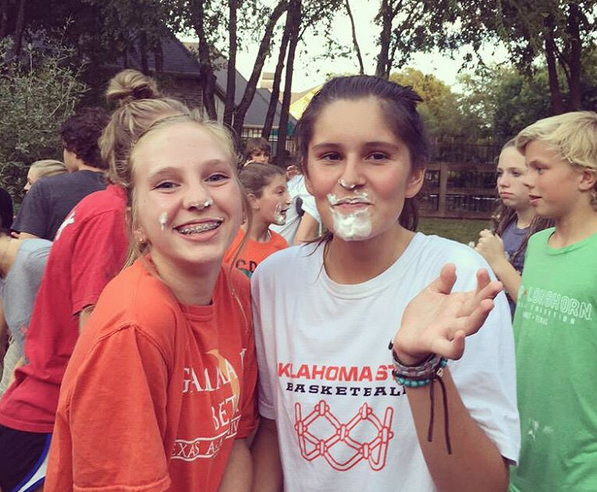 Eighth-graders Madeline Sanders and Lily Herran pose for a photo during a Willow Spings FCA meeting. This event was led by high school FCA students. 
