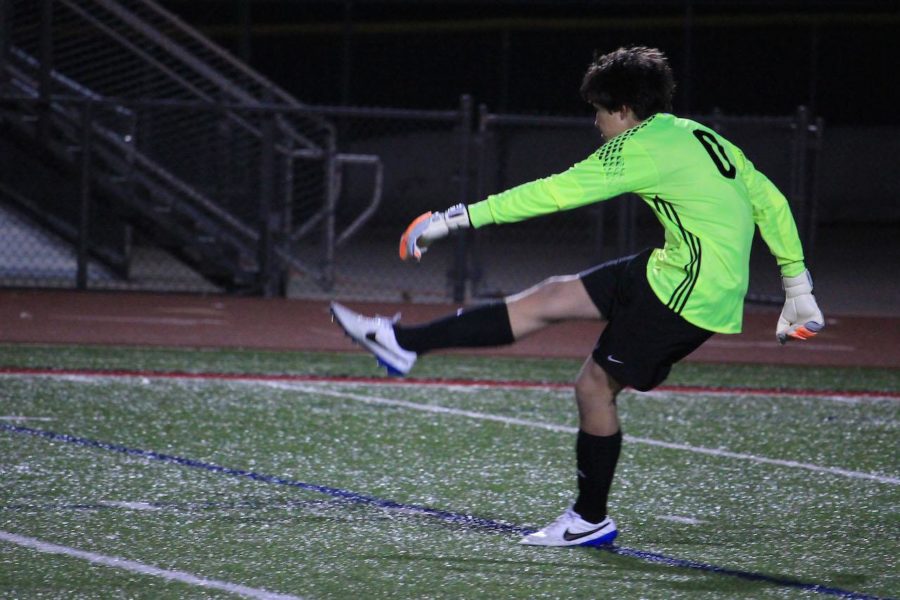Goalie Shane Gentry punts the ball after a save against the last varsity boys game.
