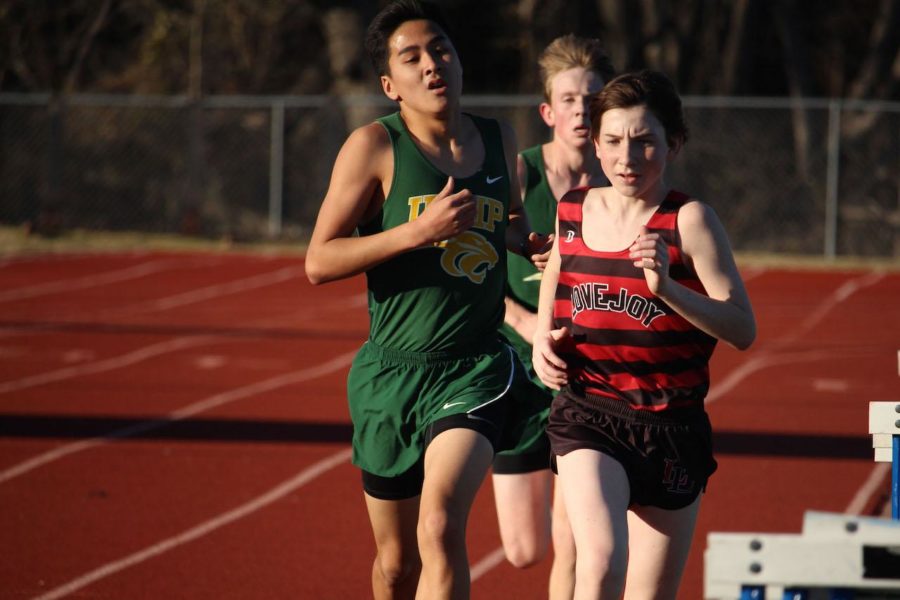While running Varsity 3600, Collin Jones sprints past two UNHP racers.