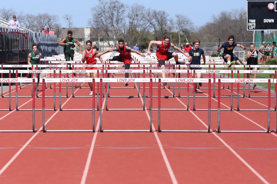 Neck and neck with Tyler Van-Wagoner (5), sophomore Reece Field (4) comes over the hurdle. Field placed first in the 100 meter hurdles with Van-Wagoner coming in just .02 seconds behind, placing second. Blake Pfaff, also pictured came in fourth.