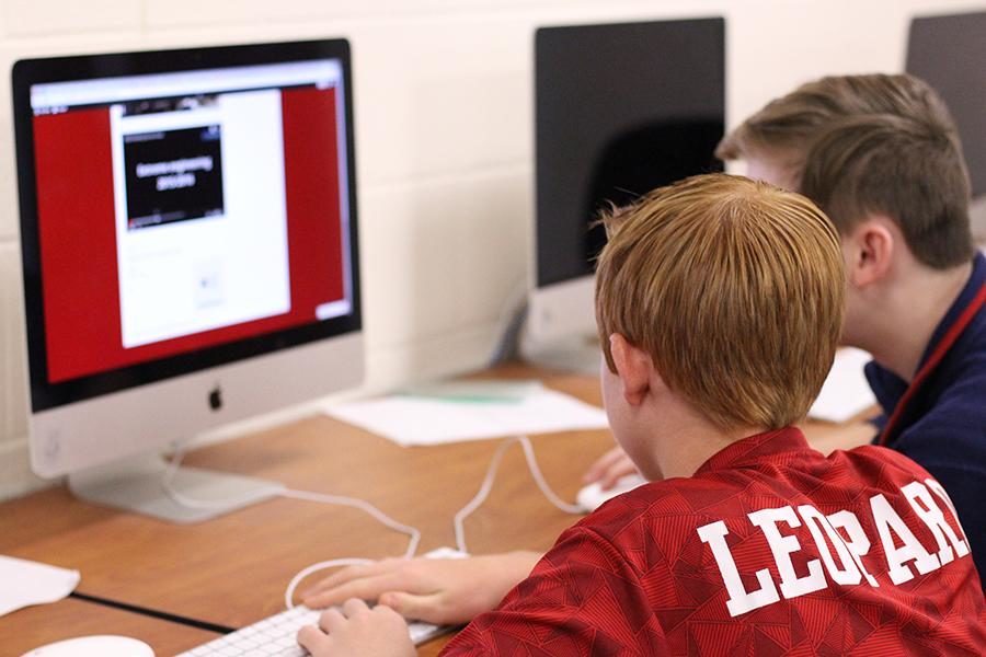 Two of the three team members, Pierce Richardson and Caiden Tays, work on developing their website during class.