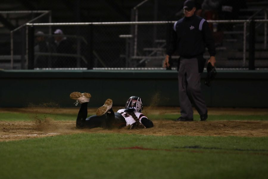 Junior Kylee Ramos (15) slides across home plate in the game against Wylie.