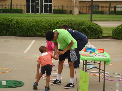 Jalen Fields helps one of the young participants during his “Get Fit 4 Christ Mini Sports Camp” at LightChurch.